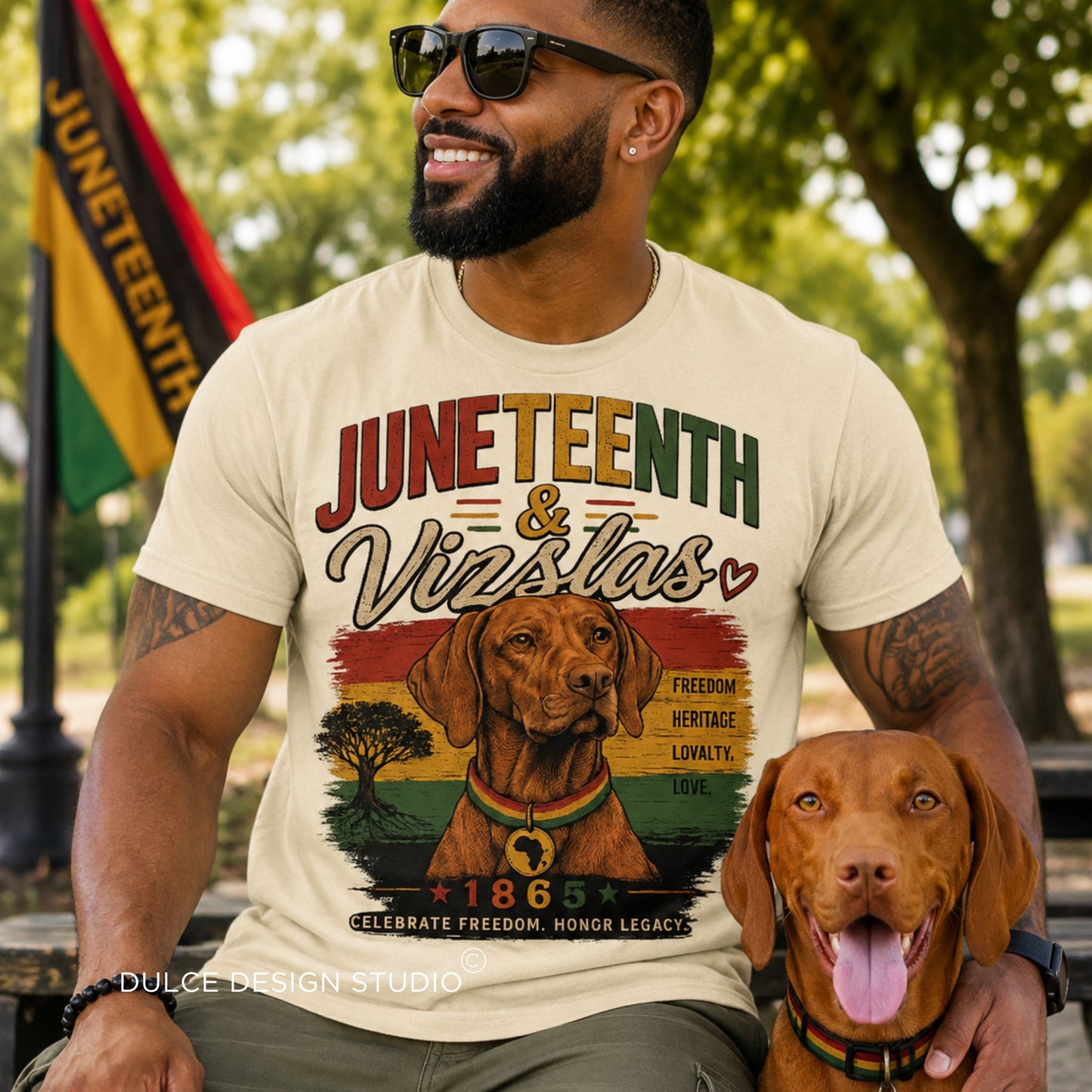 Man wearing a 'Juneteenth & Vizslas' t-shirt with a dog, sitting outdoors.
