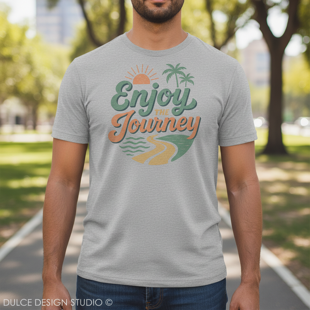 Person wearing a gray t-shirt with 'Enjoy the Journey' graphic in a park setting