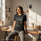 Woman wearing a t-shirt with a fantasy design in a bright room with artwork on the wall.