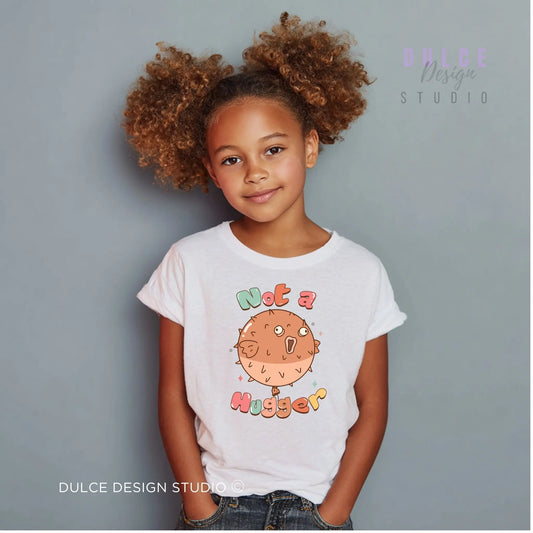 Child wearing a white t-shirt with a colorful graphic and text against a gray background