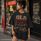 Woman wearing a black 'Old School' graphic t-shirt in front of a record store.