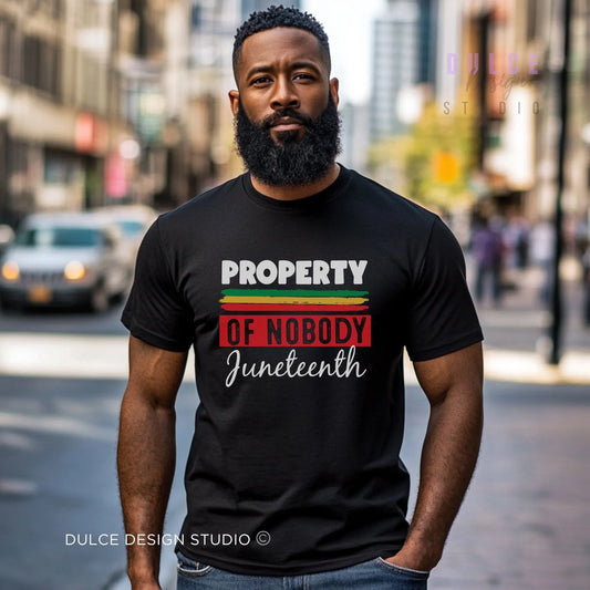 Man wearing a black t-shirt with 'Property of Nobody Juneteenth' text on a city street.