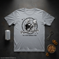 Gray t-shirt with a skull graphic and text on a dark surface with a can, bottle opener, and bowl of nuts.