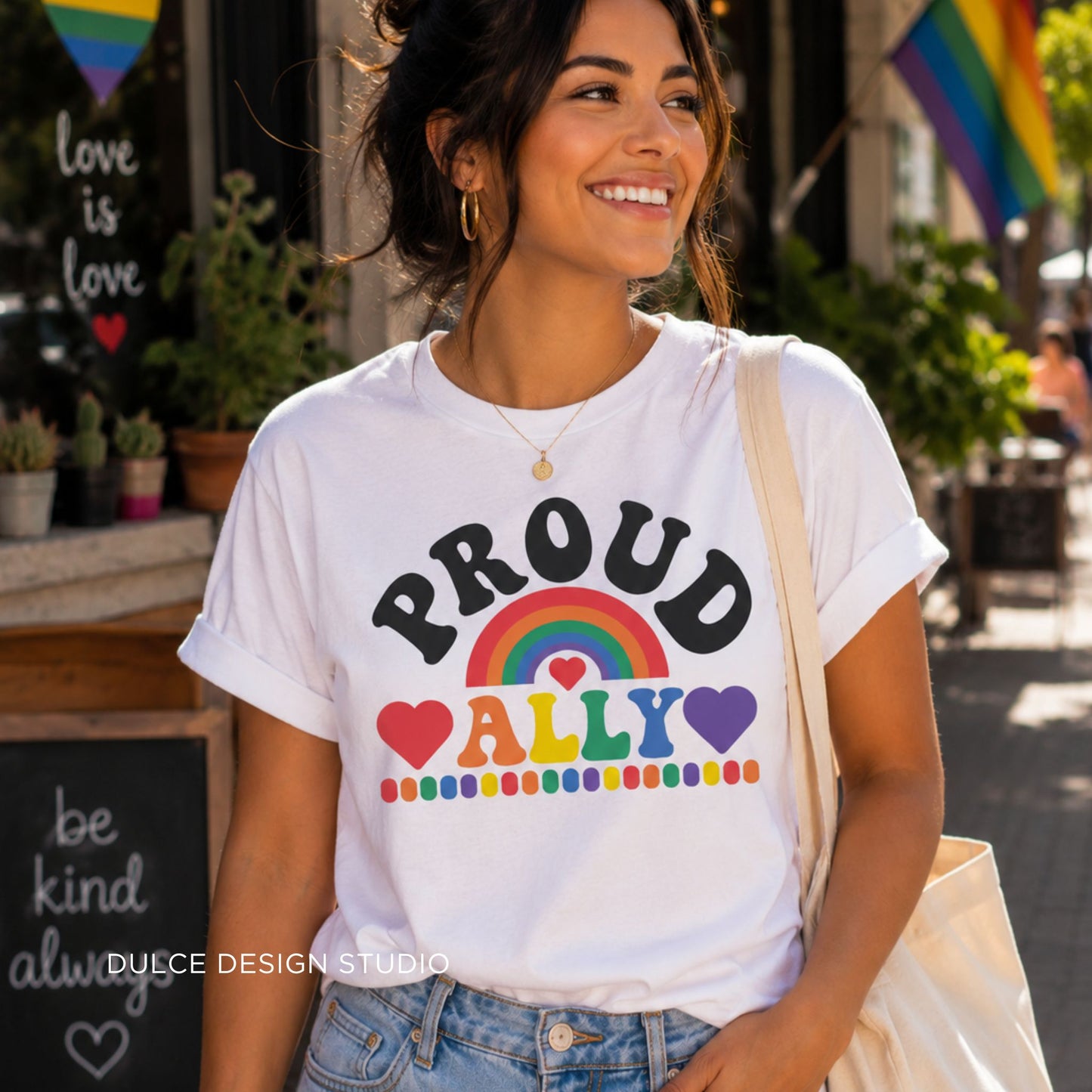 Woman wearing a white t-shirt with 'PROUD ALLY' design, standing outdoors.