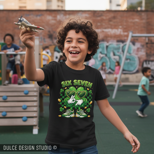 Child holding a toy airplane with a graphic t-shirt in an outdoor playground setting.