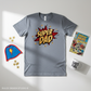 Gray t-shirt with 'Super Dad' print, superhero cape, mug, and comic book on a light gray background.