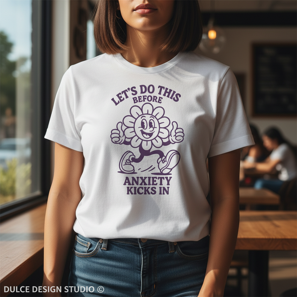 Person wearing a white t-shirt with a purple graphic and text in a casual setting.