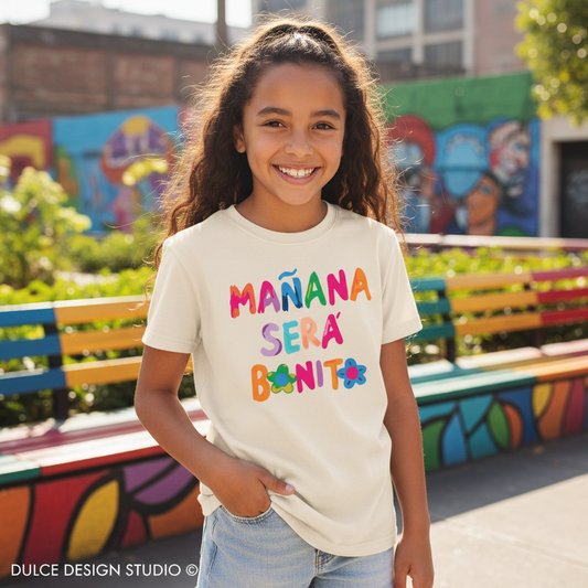 Young girl wearing a colorful t-shirt with text in an outdoor setting